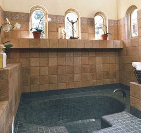 The mix of tiles in this bathroom gives the look of an ancient bathhouse.