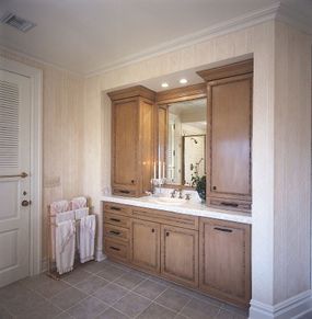 Custom-made bathroom cabinets are trimmed in bamboo for a subtly exotic touch.