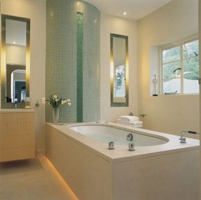 The curved wall of green glass makes a fine focal point, reminding bathers of a waterfall.