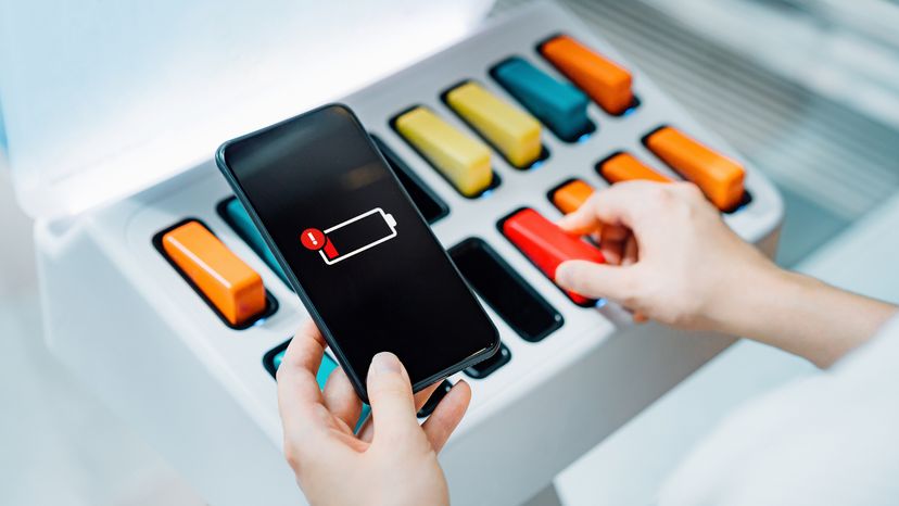 Woman holding phone out of battery