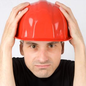 man in hardhat looking frustrated