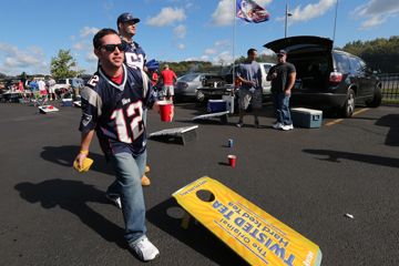 man plays bean bag toss