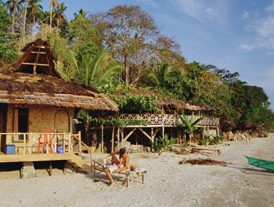 Beachfront bungalows along the shore of Bunaken Island near in Indonesia