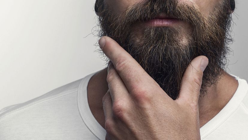 man stroking beard