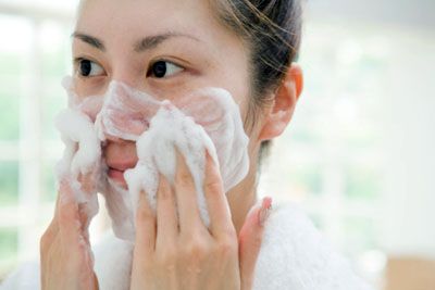 woman washing her face