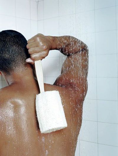 person showering with a loofah