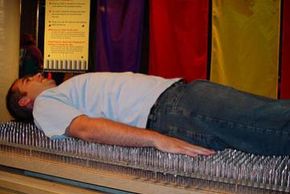 Bodily Feats Image Gallery The large nails used to make a bed of nails often aren't very sharp. Sometimes, they're not sharp enough to puncture a balloon on contact. See more bodily feats pictures.