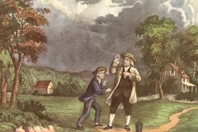 Benjamin Franklin and his son, William, using a kite and key during a storm to prove that lightning was electricity.