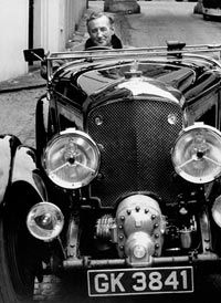 "James Bond" creator Ian Fleming sits behind the wheel of a Bentley, Bond's original vehicle of choice.”border=