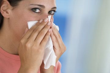 woman sneezing tissue