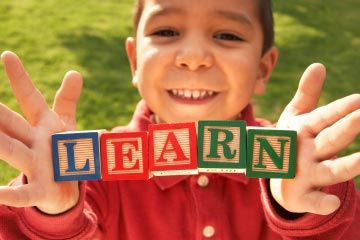 little boy holding blocks