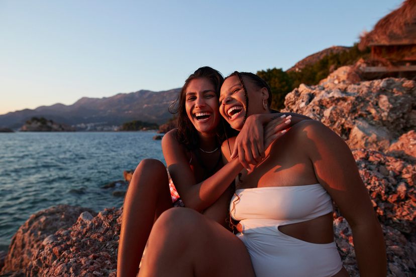 Best friend enjoying sunset together at beach