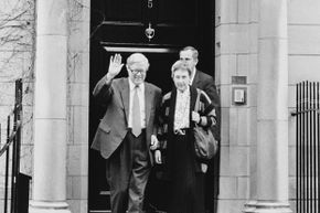 British Conservative politician Geoffrey Howe leaves his London home for the House of Commons, prior to giving his famous resignation speech criticizing Margaret Thatcher. With him is his wife Elspeth Howe.