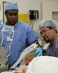 Anesthesiologist Rondall Lane (left) sedates a man before an operation in 2005.