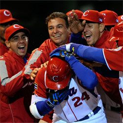 Frederich Cepeda, #24 of Cuba, is mobbed by teammates and team doctor Antonio Castro, top center, son of Fidel Castro, after hitting a three-run home run to end the game against Mexico in the 2009 World Baseball Classic.