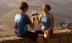 Couple enjoying wine on bike tour. 