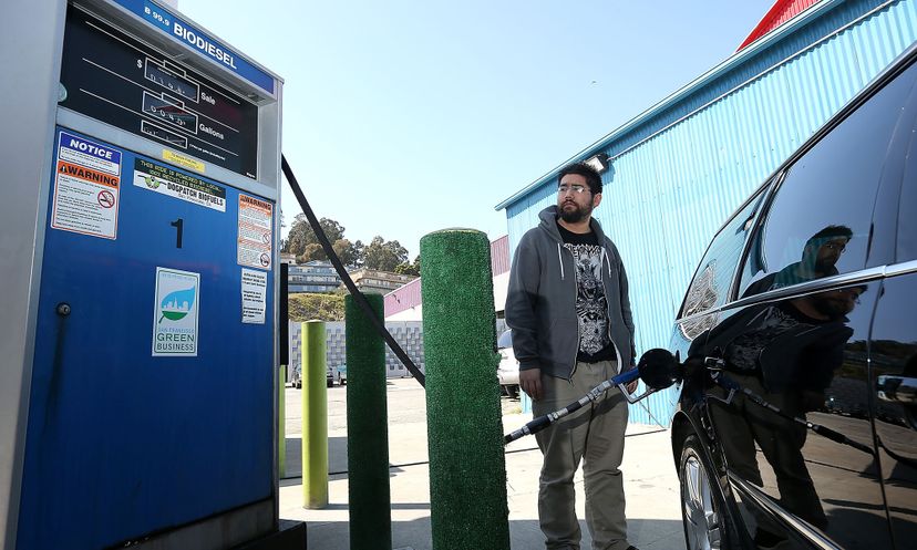 A man filling up a vehicle with biodiesel.&nbsp;