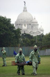 Indian soldiers shift an injured man to an emergency treatment center during a mock exercise in the event of a Chemical and Biological terror attack, in Kolkata on April 17, 2008.