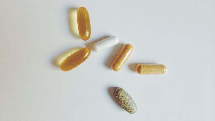Mixed herbal supplements: fish oil, biotin, turmeric, and a multivitamin.