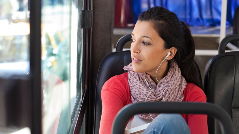 Indian woman on bus with headphones