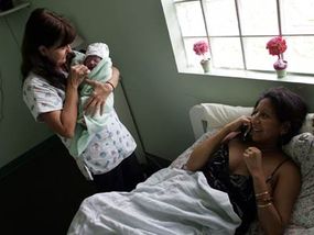 A 20-minute-old baby in the arms of a midwife at the Birthing Center of Sout­h Florida on Oct. 16, 2006.