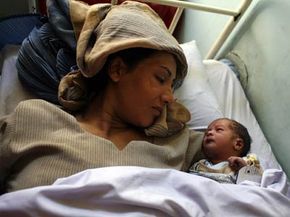 A mother and her newborn baby a day her after delivery at the Malalai Maternity hospital in Kabul, Afghanistan