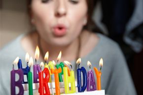 Woman blowing out birthday candles