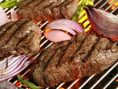 fillet mignon on the grill with grilled oinons