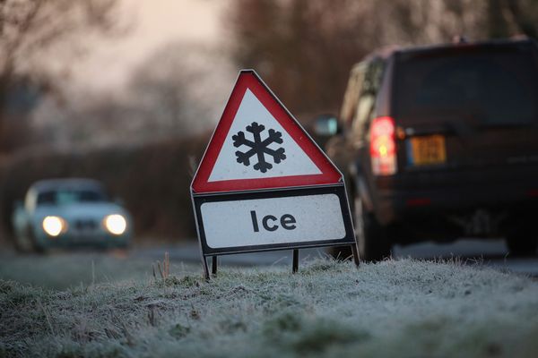 A warning triangle alerts drivers to an icy road in Knutsford, England.