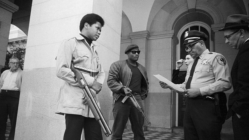 Two Black Panthers are met on the steps of the State Capitol in Sacramento by Police Lt. Ernest Holloway. Holloway told them they could keep their weapons if they did not disturb the peace. Earlier, party members had invaded the Assembly chambers and had their guns taken away. Bettmann/Getty Images