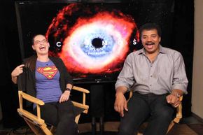 Astrophysicist/author Neil deGrasse Tyson (R) shares a laugh at Comic-Con in San Diego, California in 2013.