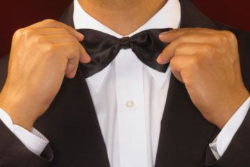 man adjusting bowtie