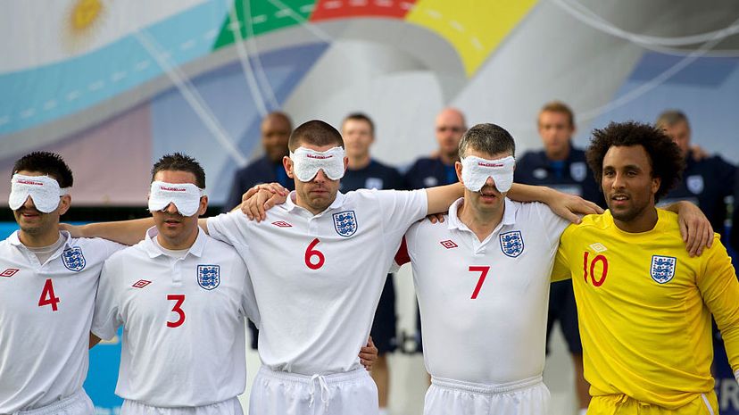 England's blind football team poses for a photo at the 2010 IBSA World Blind Football Championship in England. Rules dictate that the visually impaired players must wear blindfolds but the goalkeeper may be sighted. AMA/Corbis via Getty Images