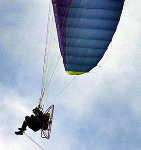 Man controlling a paraglider