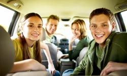 family with teens in car