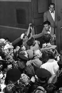 Fans mob heartthrob crooner Frank Sinatra.