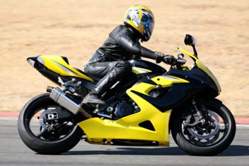 Biker in helmet and gear on motorcycle