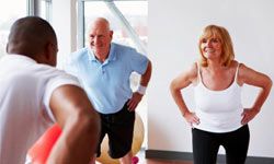 older couple working out with trainer