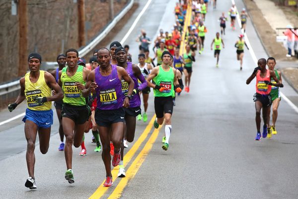 Competitive runners race in a sports jogging event.