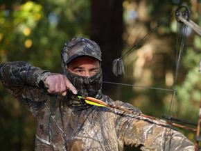 A bow hunter as he takes aim.
