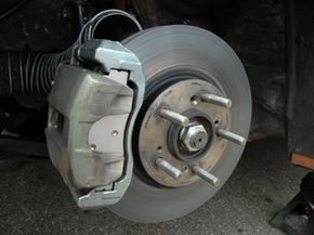 Close-up of a brake caliper on a vehicle's wheel.