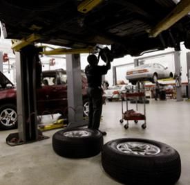 Tyrone Browley replaces the brakes on a Lexus LX470 at a dealership July 10, 2003 in Chicago, Illinois. See more car safety pictures.