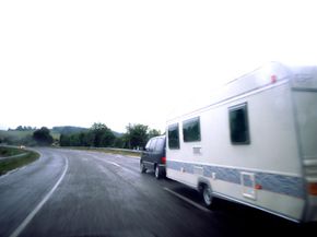 A minivan towing a mobile home