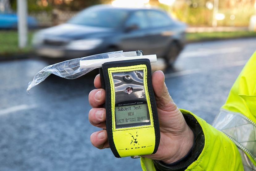 Police officer in Belfast, Northern Ireland, holds an operational breathalyzer