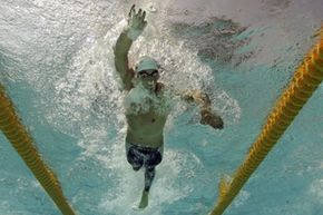 US swimmer Michael Phelps fully exhales while swimming in a qualifying heat of the 200-meter freestyle at the Olympic Aquatic Centre during the 2004 Olympic Games in Athens, Sunday, Aug. 15, 2004.