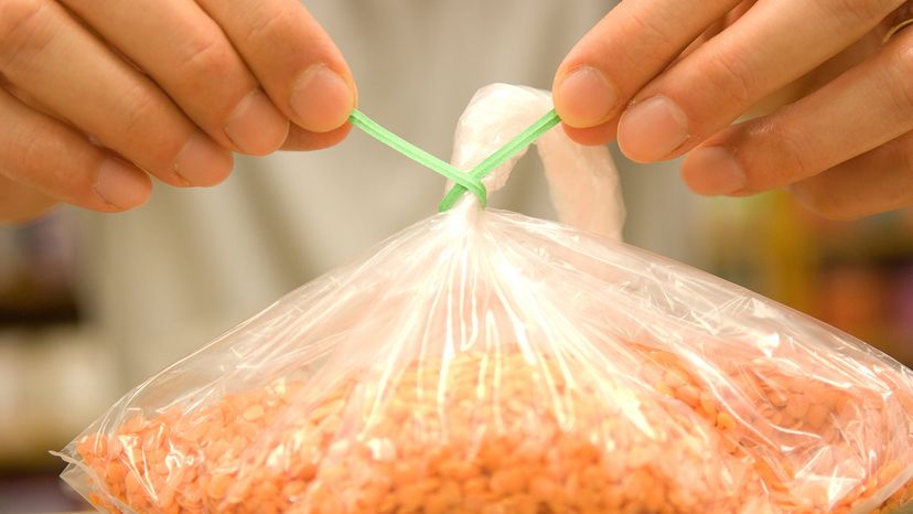 Hands tying bag of cereal in health food store