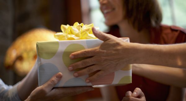 Two people exchange a gift.