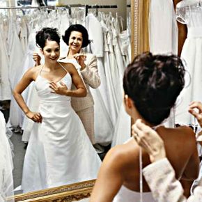 Bride and her mother choosing a wedding dress