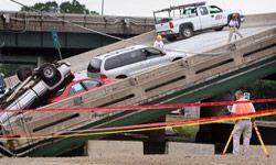 FBI agents investigate the collapse of the I-35W Bridge in Minneapolis, a disaster apparently caused by an inherent design weakness. See more bridge pictures.