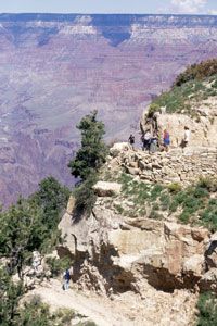 As hikers descend, they take in wonderful views of the Grand Canyon.